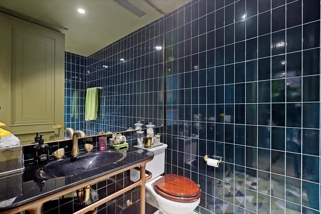 a bathroom with a toilet a sink and a mirror