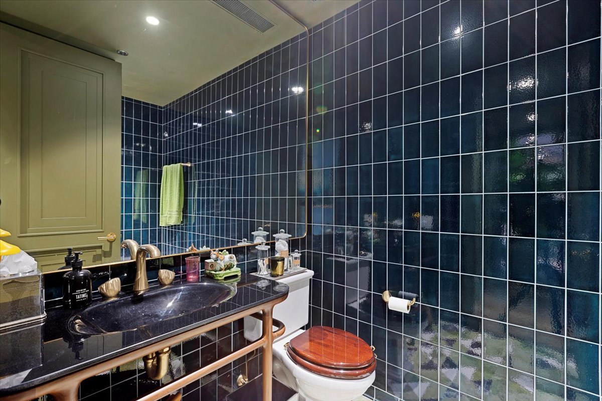 159 East Walton Place, Unit 8C Chicago, IL 60611 - Photo 23 of 28 a bathroom with a toilet a sink and a mirror