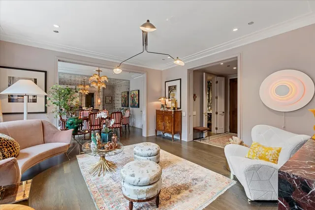 a living room with furniture and a chandelier