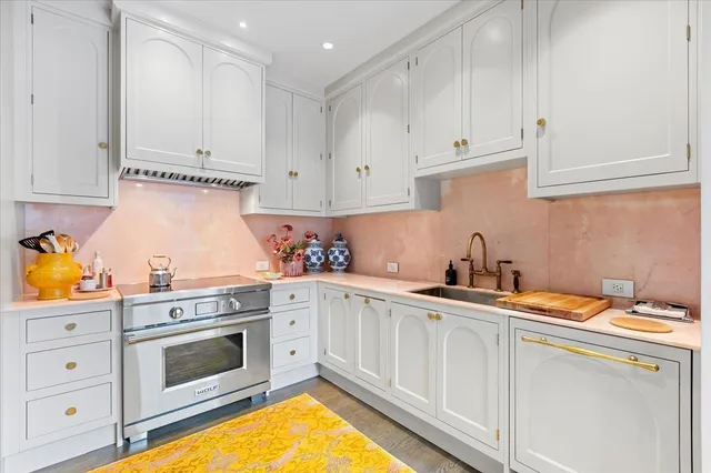 a kitchen with granite countertop white cabinets and white appliances