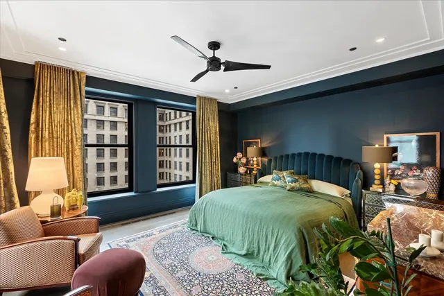 a bedroom with a bed couch and a large window