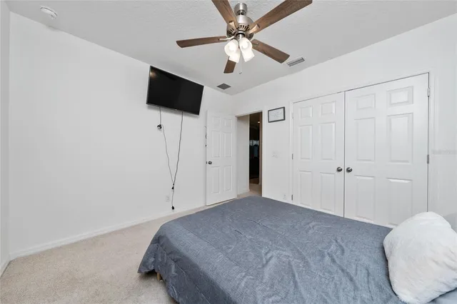 a view of a livingroom with a ceiling fan and window
