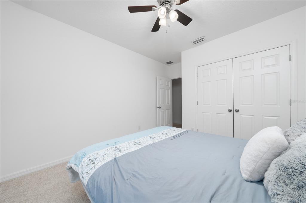 669 Jupiter Beach Road Groveland, FL 34736 - Photo 17 of 41 a bedroom with a bed and cabinets