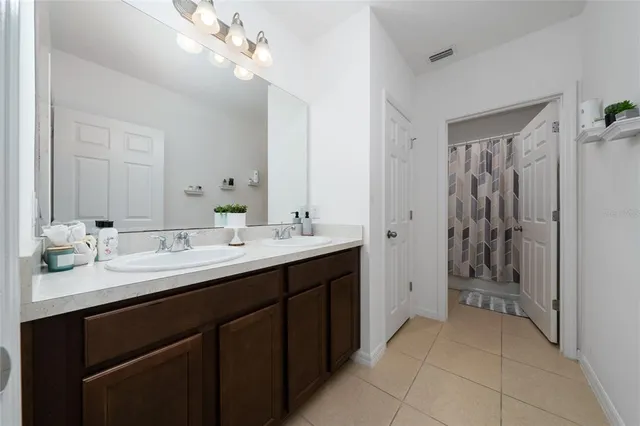 a bathroom with a double vanity sink and a mirror