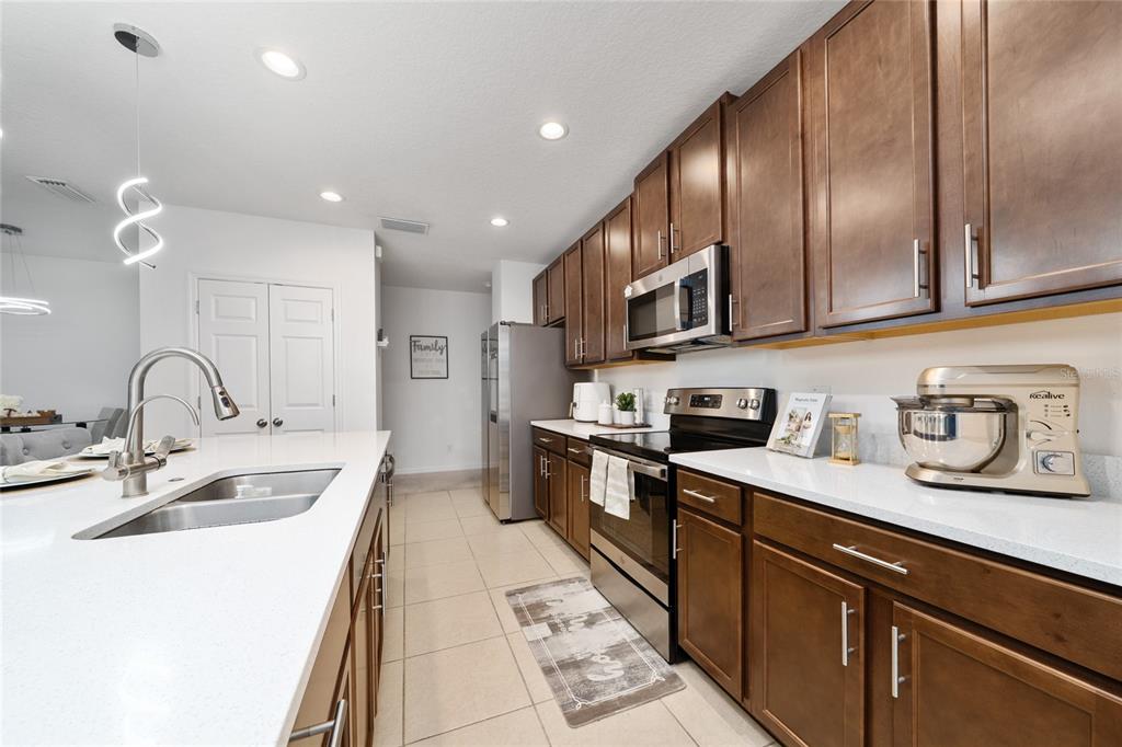 669 Jupiter Beach Road Groveland, FL 34736 - Photo 2 of 41 a kitchen with stainless steel appliances granite countertop a sink stove and cabinets