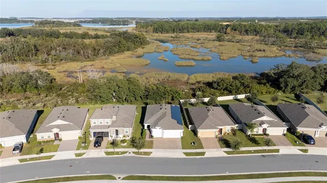 an aerial view of residential houses with outdoor space