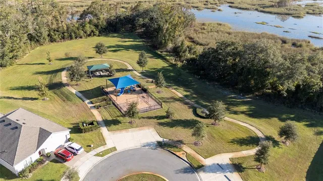 an aerial view of a house with swimming pool and lake view