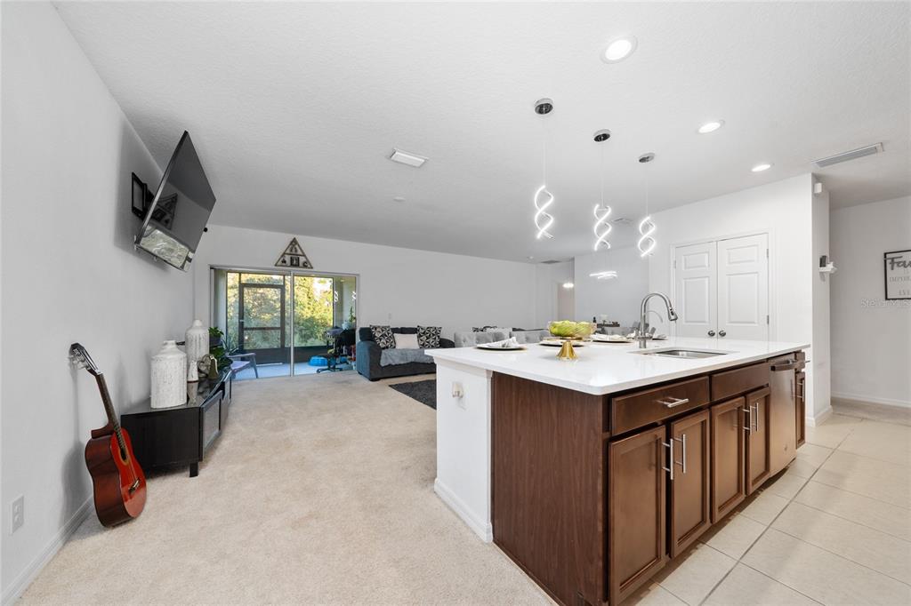 669 Jupiter Beach Road Groveland, FL 34736 - Photo 3 of 41 a kitchen with a sink a counter top space and appliances