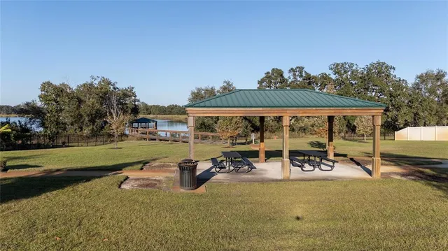 an aerial view of a house with garden space and lake view