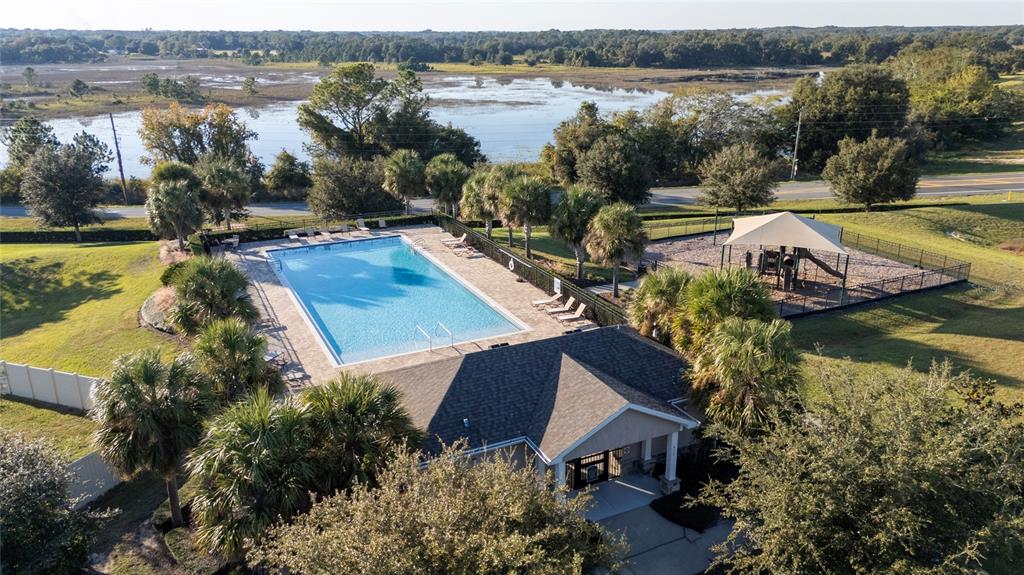 669 Jupiter Beach Road Groveland, FL 34736 - Photo 36 of 41 an aerial view of a house with garden space and lake view
