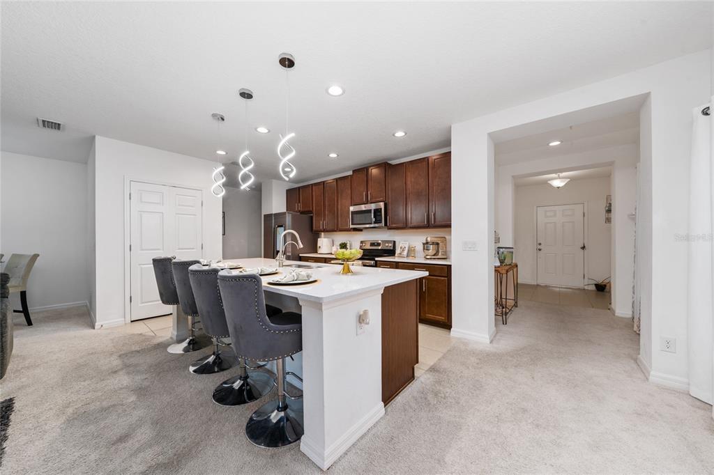 669 Jupiter Beach Road Groveland, FL 34736 - Photo 4 of 41 a large kitchen with a table and chairs