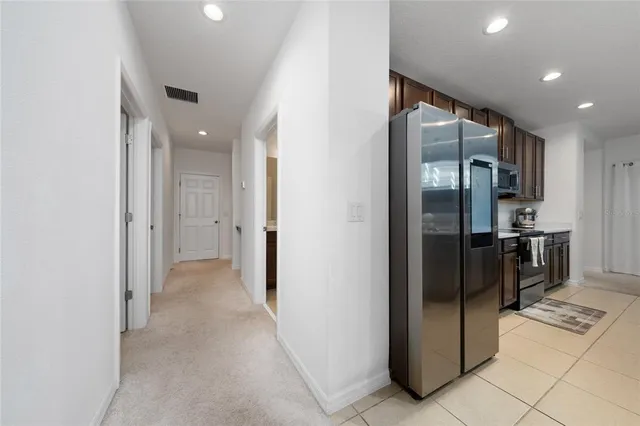 a view of a refrigerator in kitchen and a window