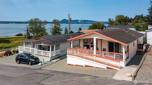 a aerial view of a house with a yard and balcony