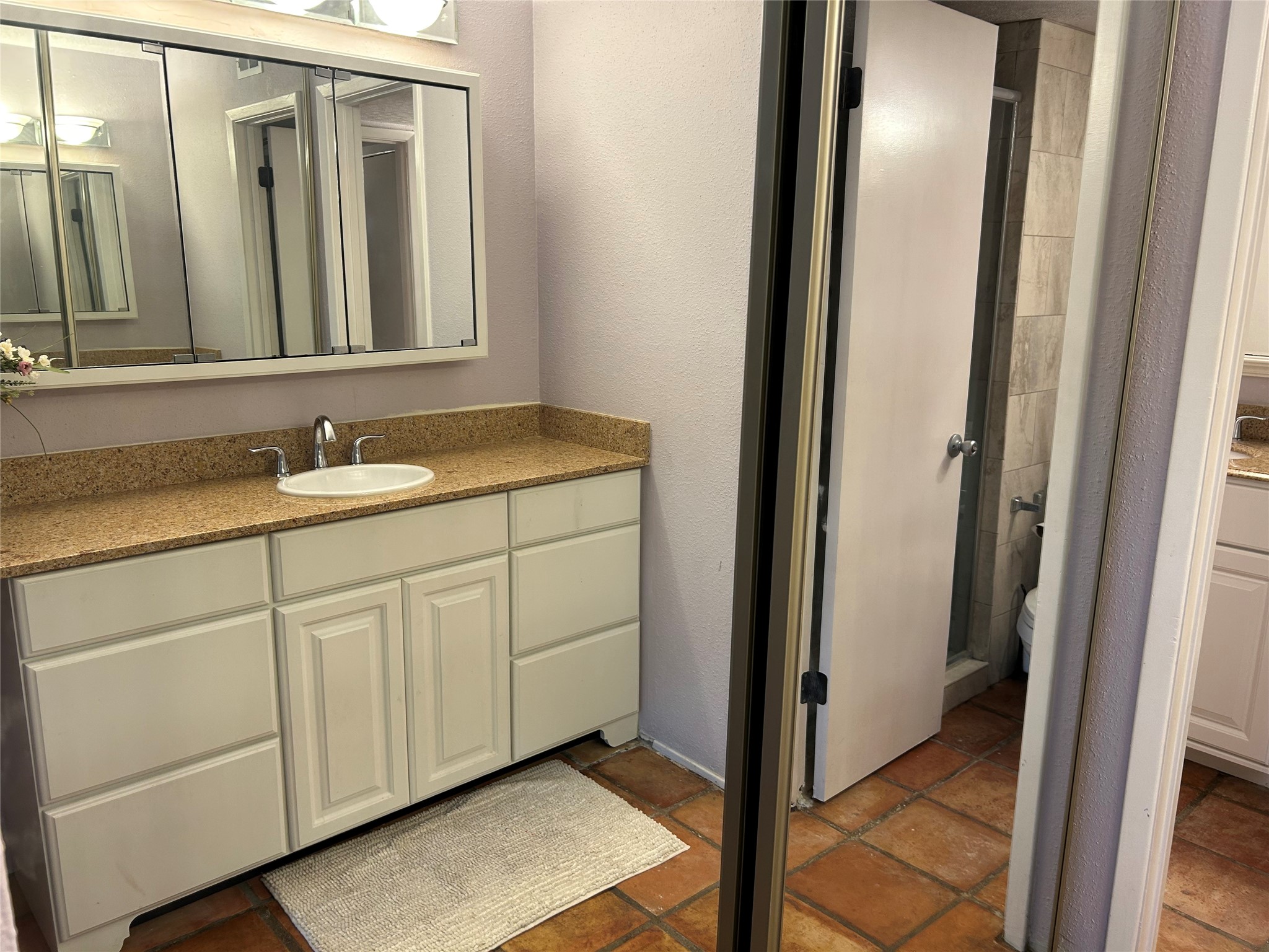 13034 Leader Street, Unit 965 Houston, TX 77072 - Photo 20 of 32 The larger vanity area and closet lead into the primary bedroom downstairs.
