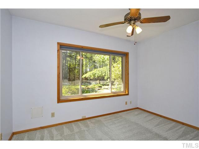 3729 Bosco Road New Hill, NC 27562 - Photo 19 of 25 Look at the view from the bedroom window. Nice size closet and ceiling fan. Bedroom