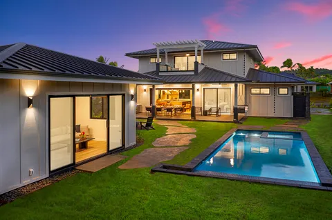 a swimming pool with yard in front of it