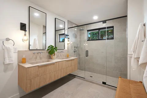 a bathroom with a bathtub sink and mirror
