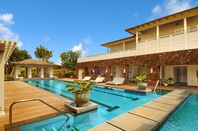 a front view of a house with patio swimming pool and outdoor seating