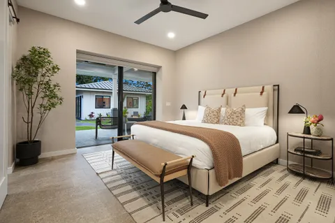 a spacious bedroom with a bed and a chandelier