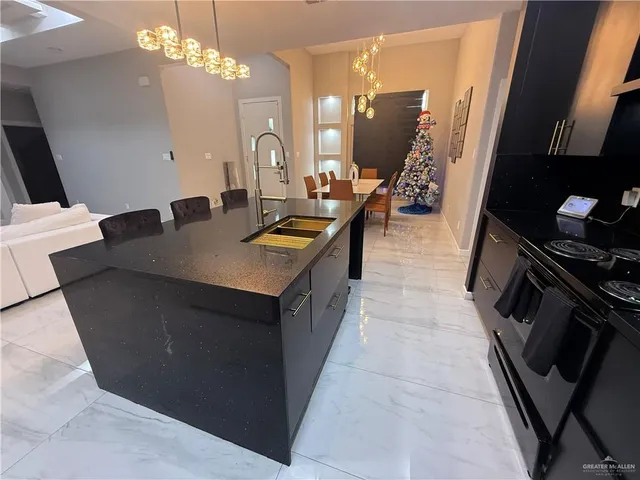 a kitchen with a sink a counter top space and appliances