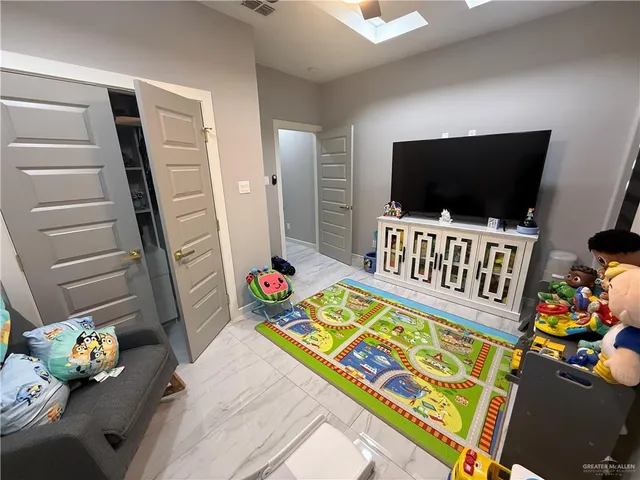 a bedroom with furniture and a chandelier