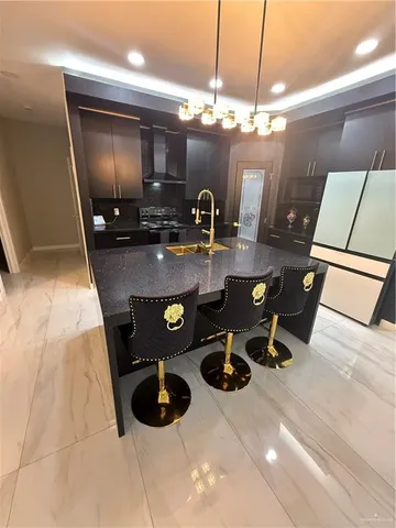 a kitchen with a sink a stove and cabinets