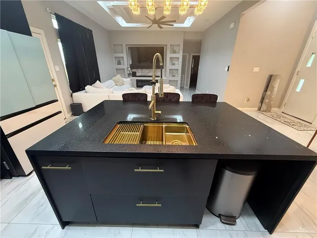 a view of kitchen with a sink and dishwasher with wooden floor