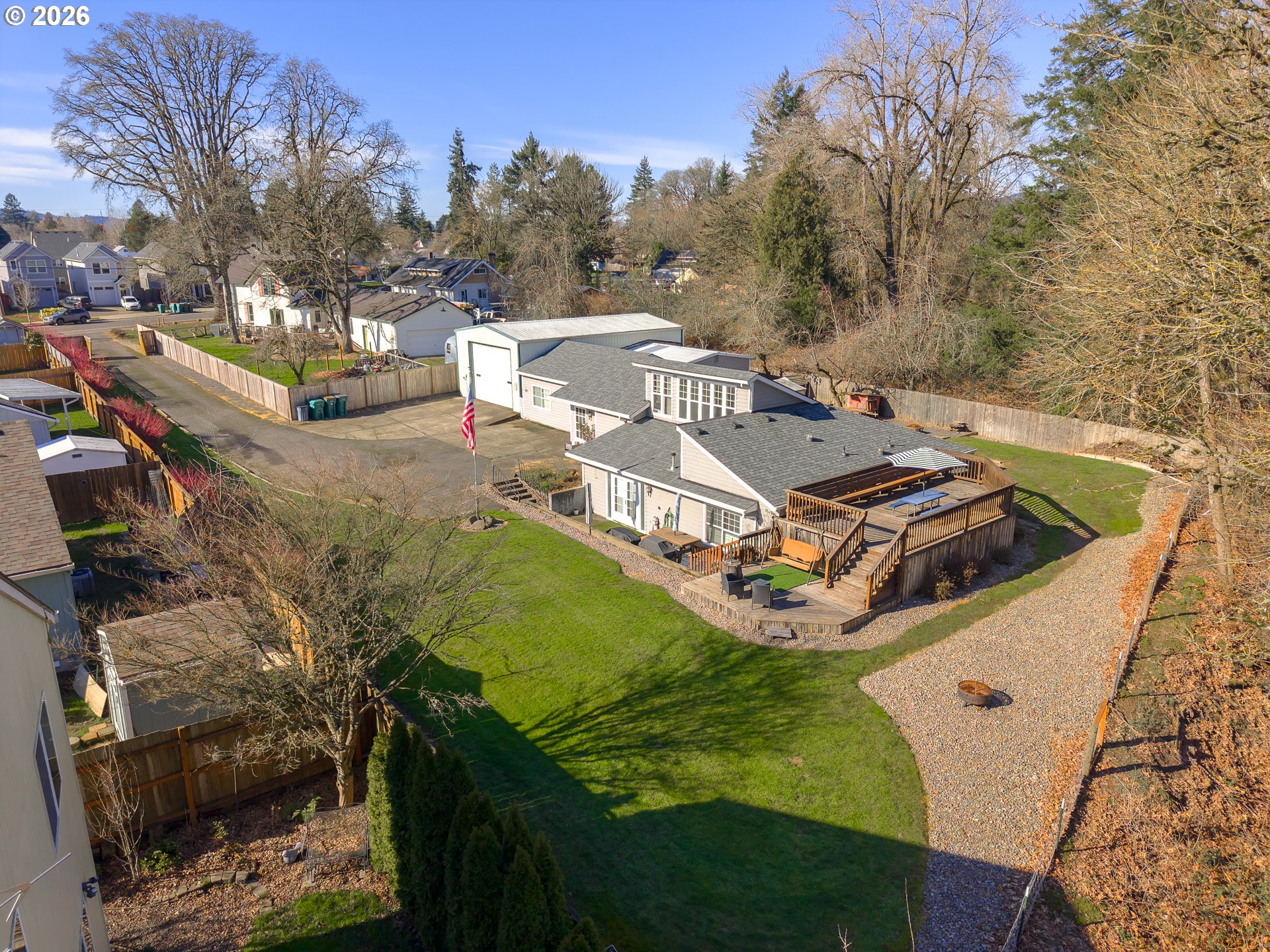 a view of a swimming pool with lawn chairs and a fire pit