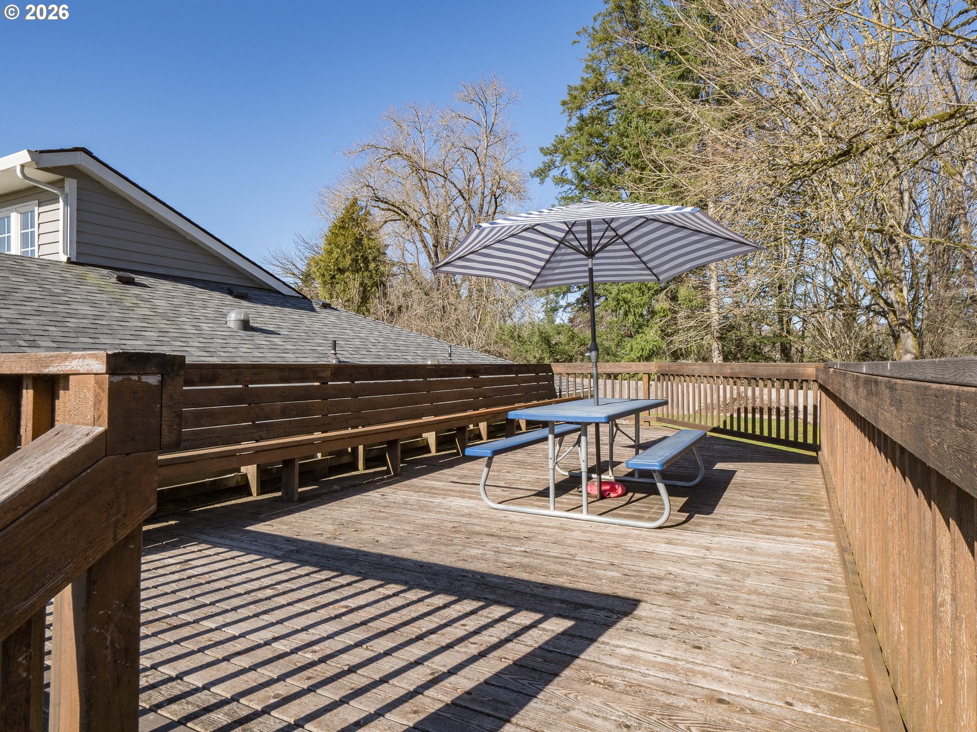 600 Wynooski Street Newberg, OR 97132 - Photo 29 of 48 a view of a roof deck with table and chairs under an umbrella with wooden floor