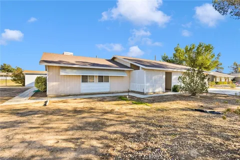 a view of a house with a yard and garage