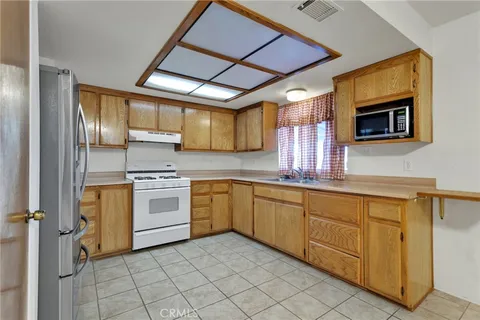 a kitchen with a stove sink and cabinets