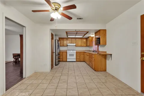 a large kitchen with stainless steel appliances a sink and cabinets