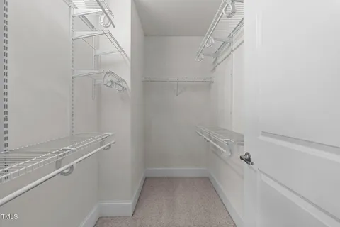 a bathroom with a shower and a glass door