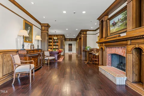 a living room with furniture a rug and a chandelier