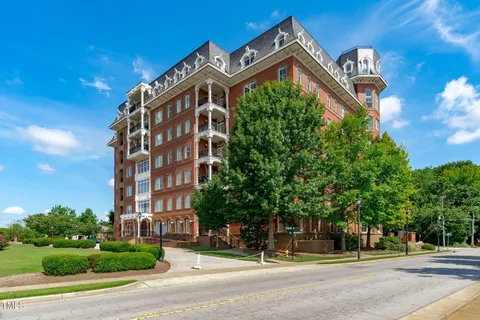 a living room with furniture pool table wooden floor and windows