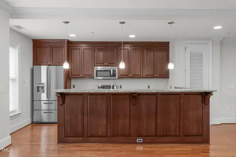 a kitchen with granite countertop a sink and steel appliances