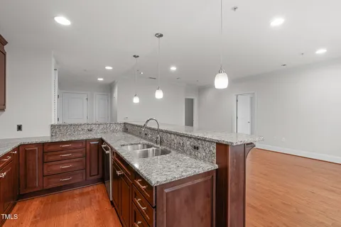 a kitchen with stainless steel appliances granite countertop a refrigerator sink and cabinets