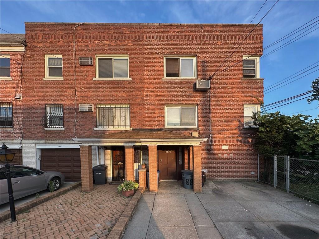 a front view of a house with yard and seating space