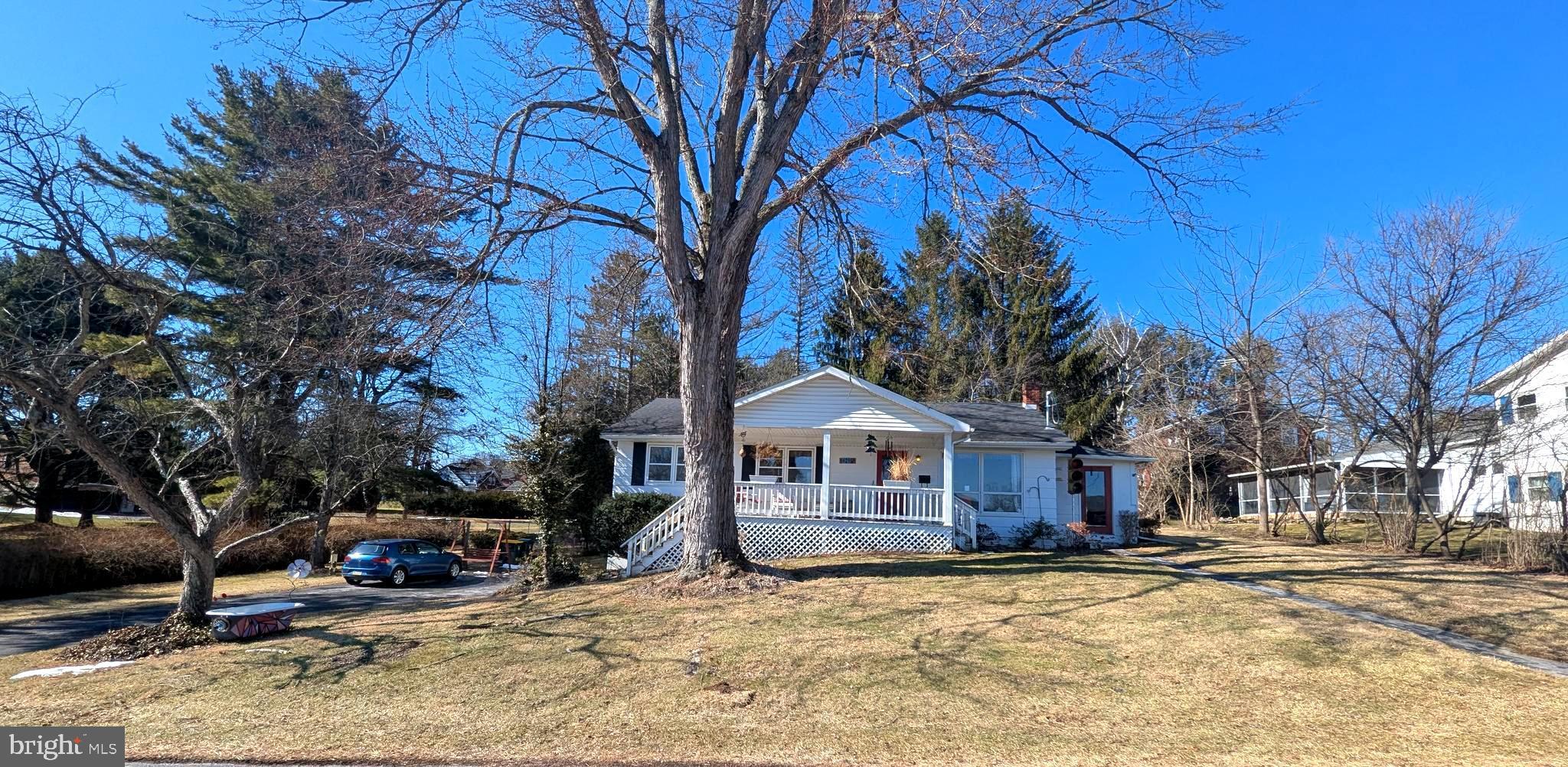 a front view of a house with a yard covered with snow