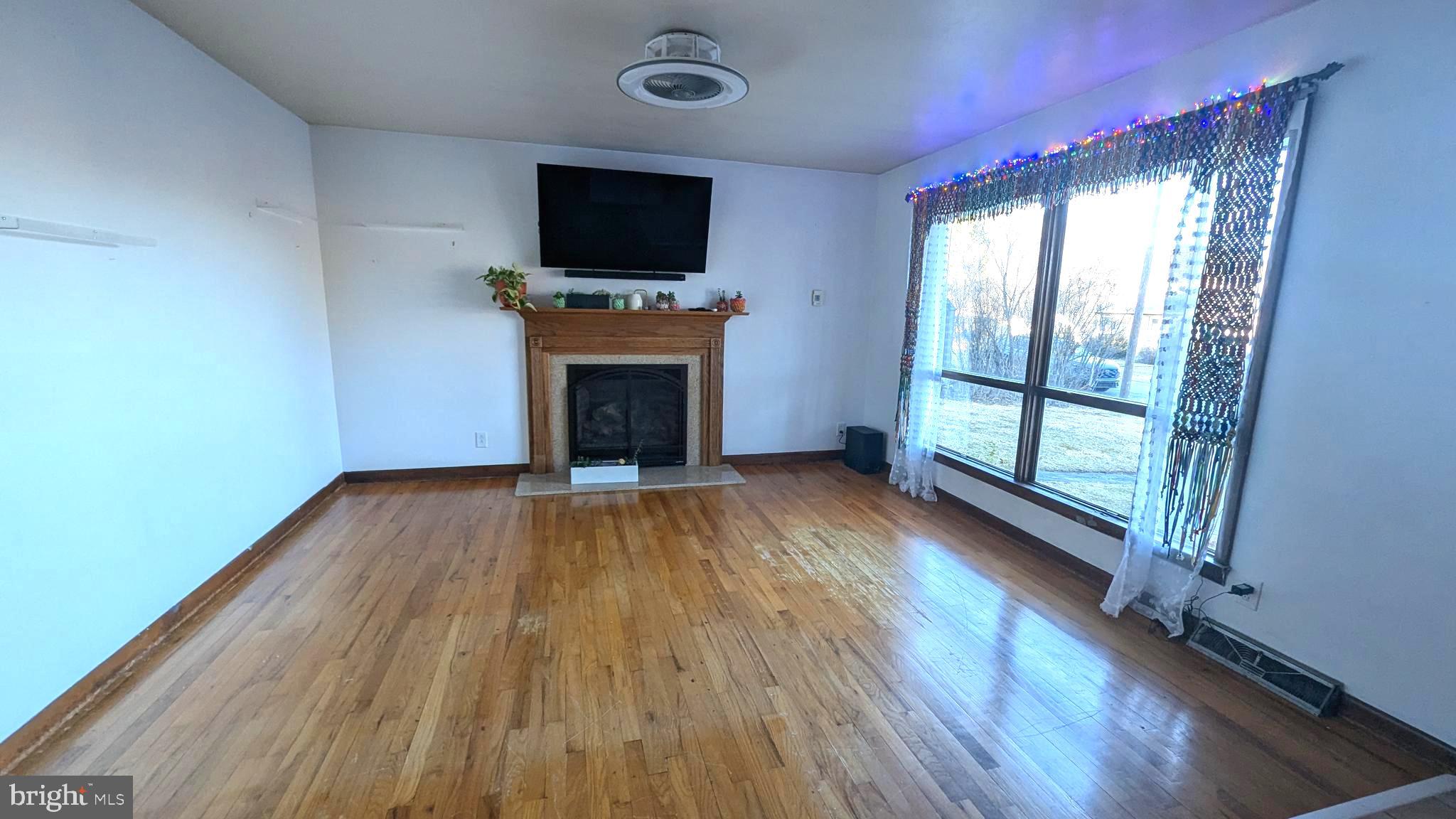 429 Simpson Street Bellefonte, PA 16823 - Photo 16 of 27 a view of empty room with wooden floor and fireplace