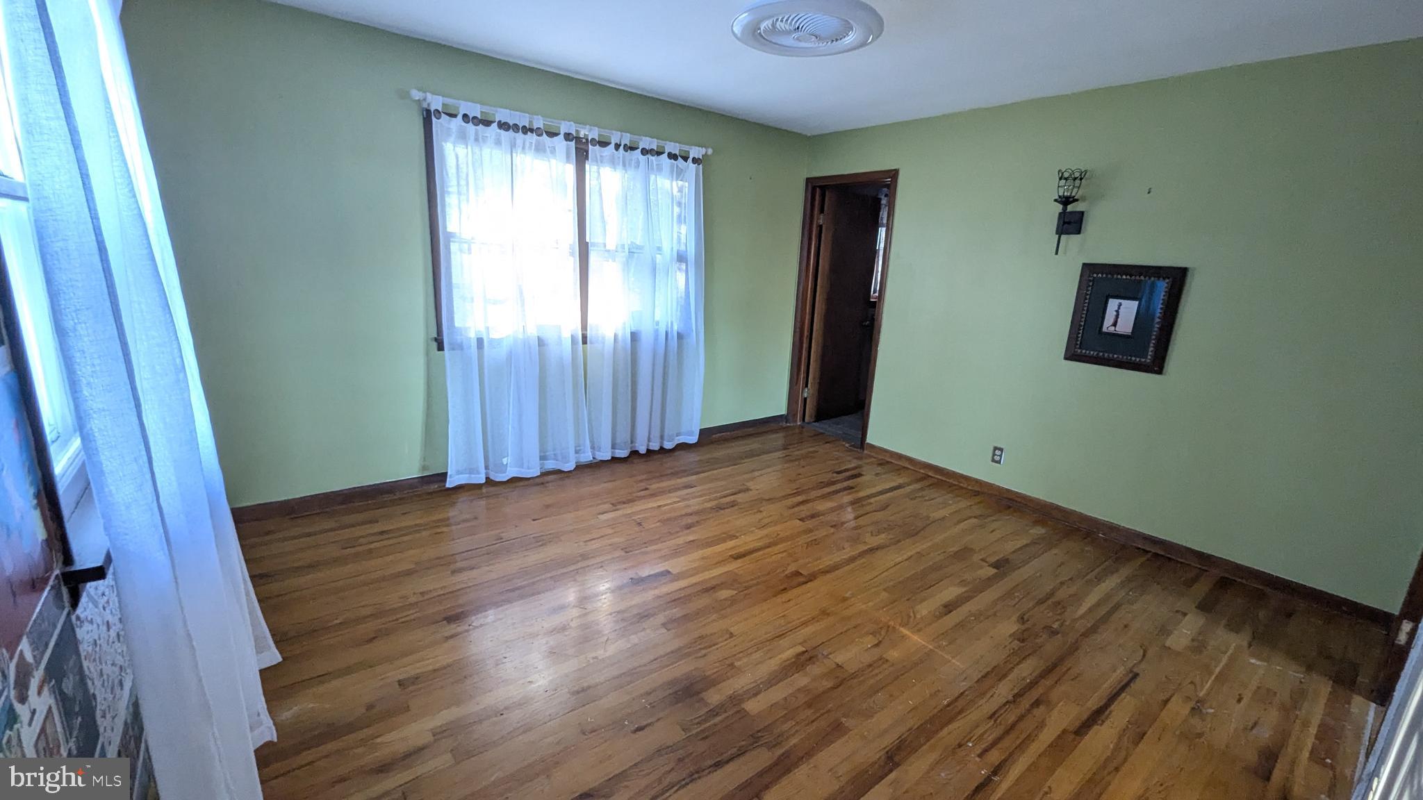 429 Simpson Street Bellefonte, PA 16823 - Photo 20 of 27 a view of an empty room with wooden floor and a window