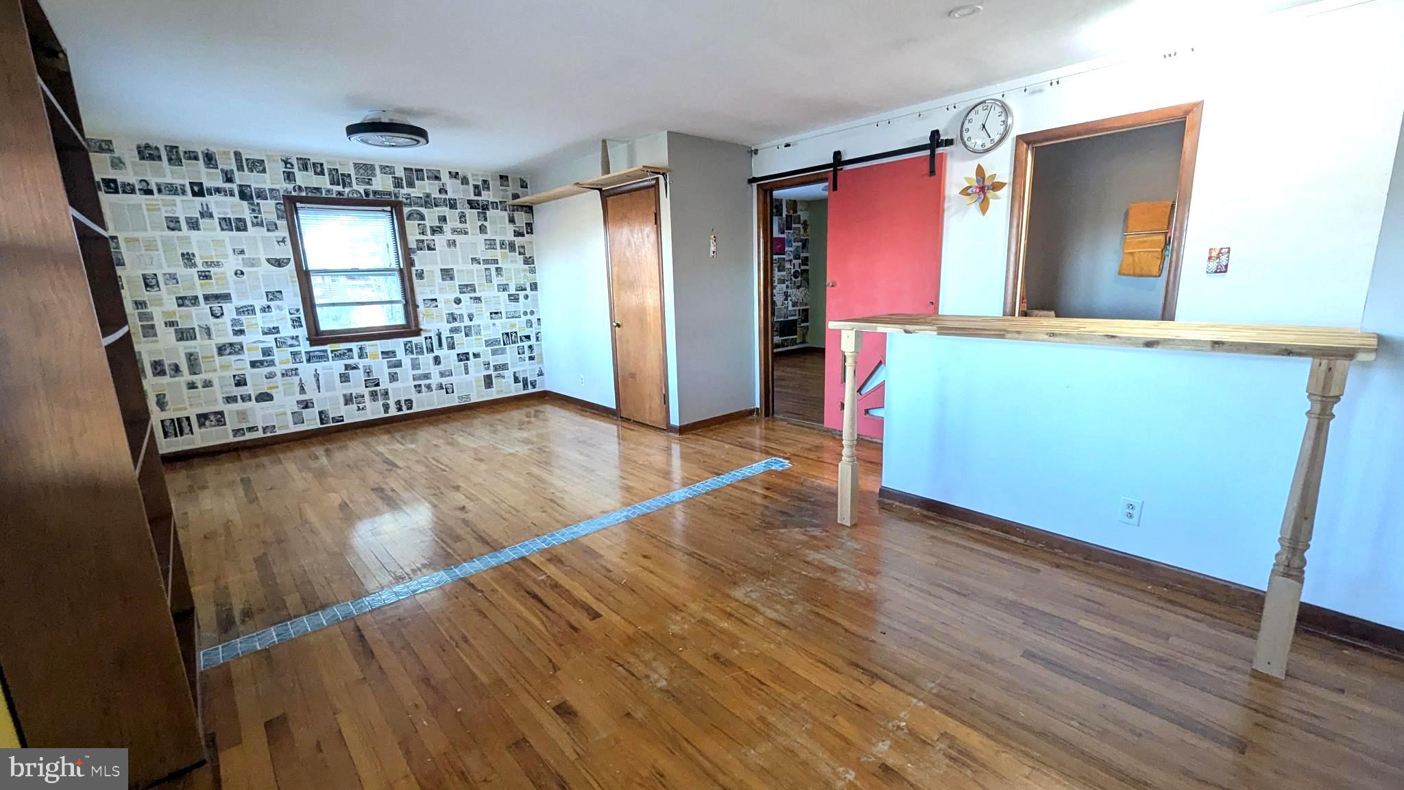429 Simpson Street Bellefonte, PA 16823 - Photo 21 of 27 wooden floor in an empty room with a window