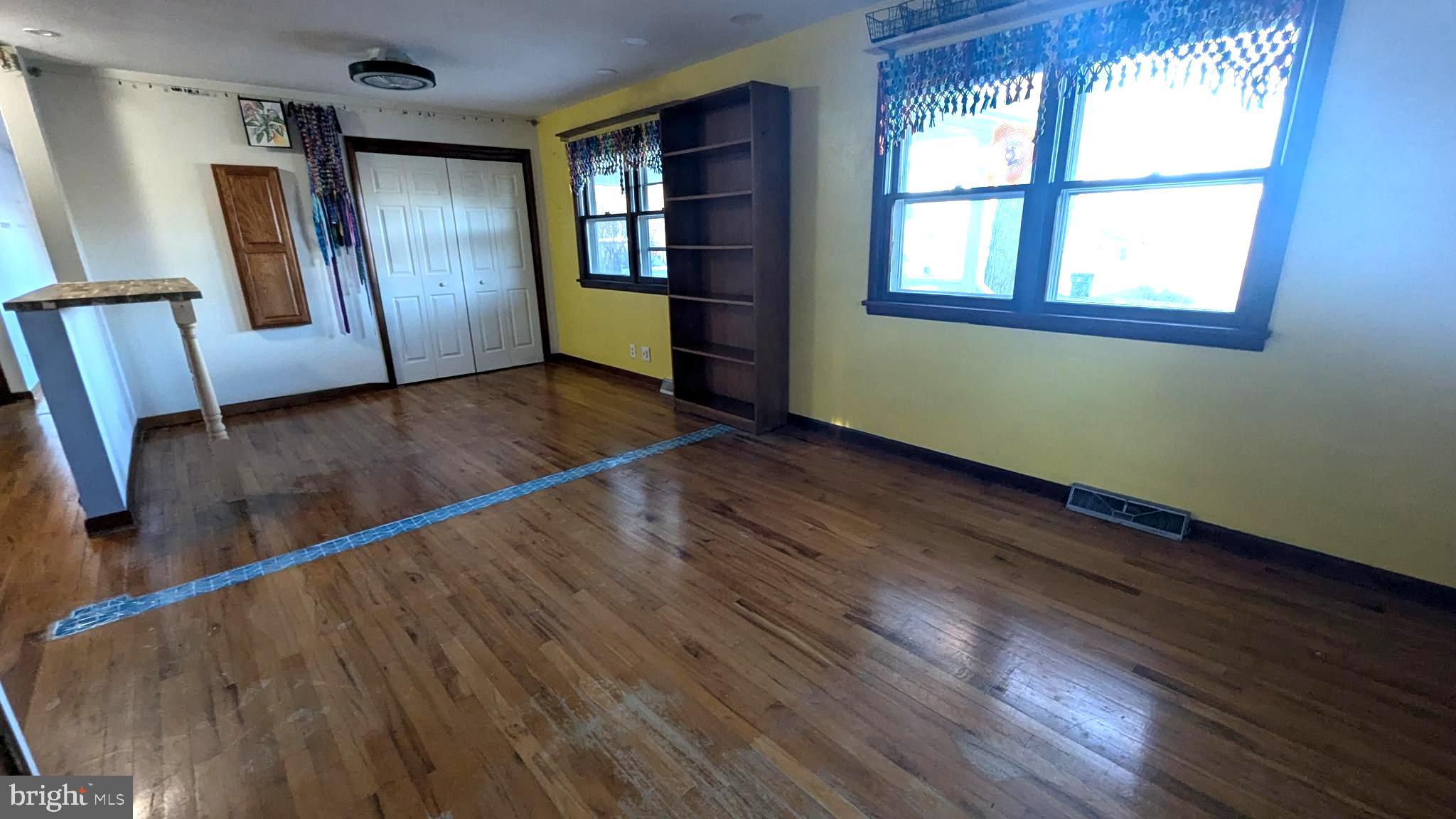 429 Simpson Street Bellefonte, PA 16823 - Photo 22 of 27 an empty room with wooden floor and windows