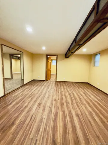 a view of an empty room and wooden floor