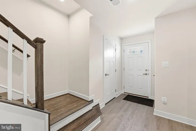 a view of an empty room and wooden floor