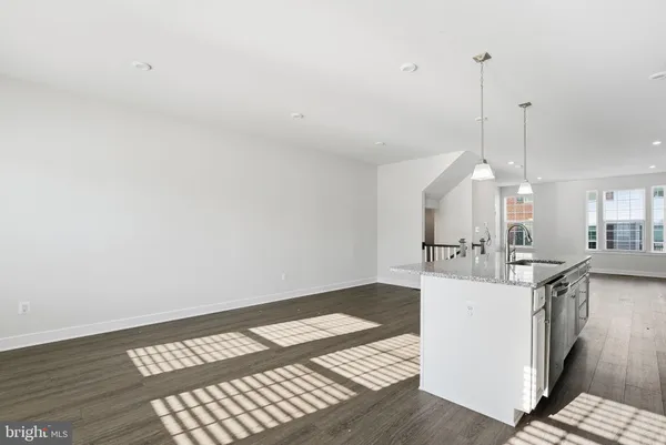a living room with a sink furniture and a view of kitchen