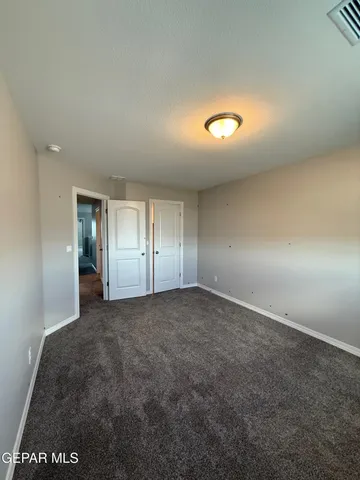 an empty room with windows and closet