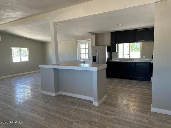 a view of kitchen and window with wooden floor