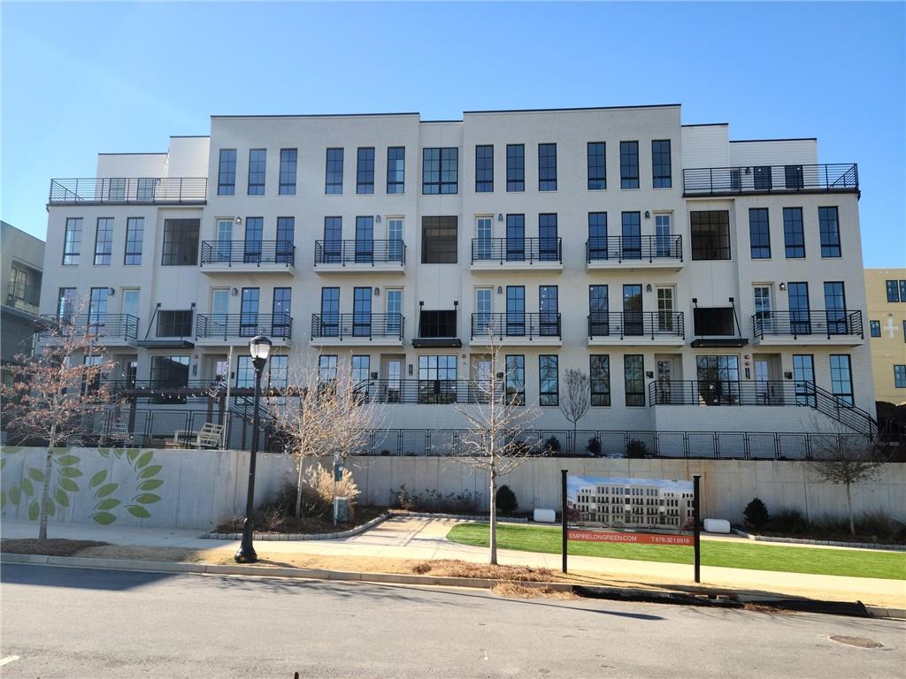 1291 Longreen Terrace Northwest, Unit 7 Atlanta, GA 30318 - Photo 1 of 1 a view of a building with a swimming pool