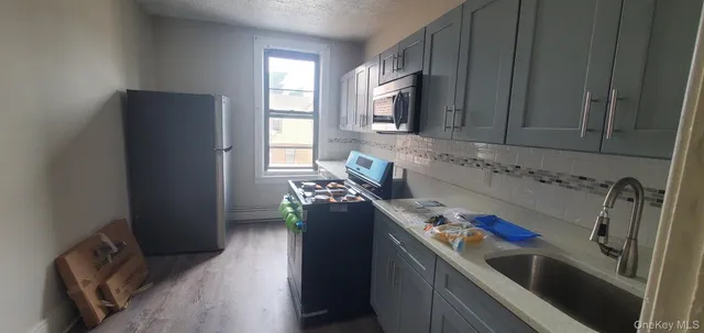 a kitchen with stainless steel appliances granite countertop a refrigerator and a sink